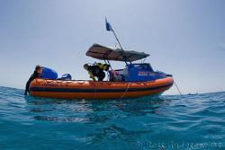 The End!  My dive buddies getting back into our boat at t... by Ross Gudgeon 